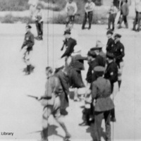 Carbon_County_Strike_Women_from_National_Miners_Union_March_confront_vanguard_of_police_forces_in_Main_Street_Still_from_film_Price_Utah_September_11_1933.jpg